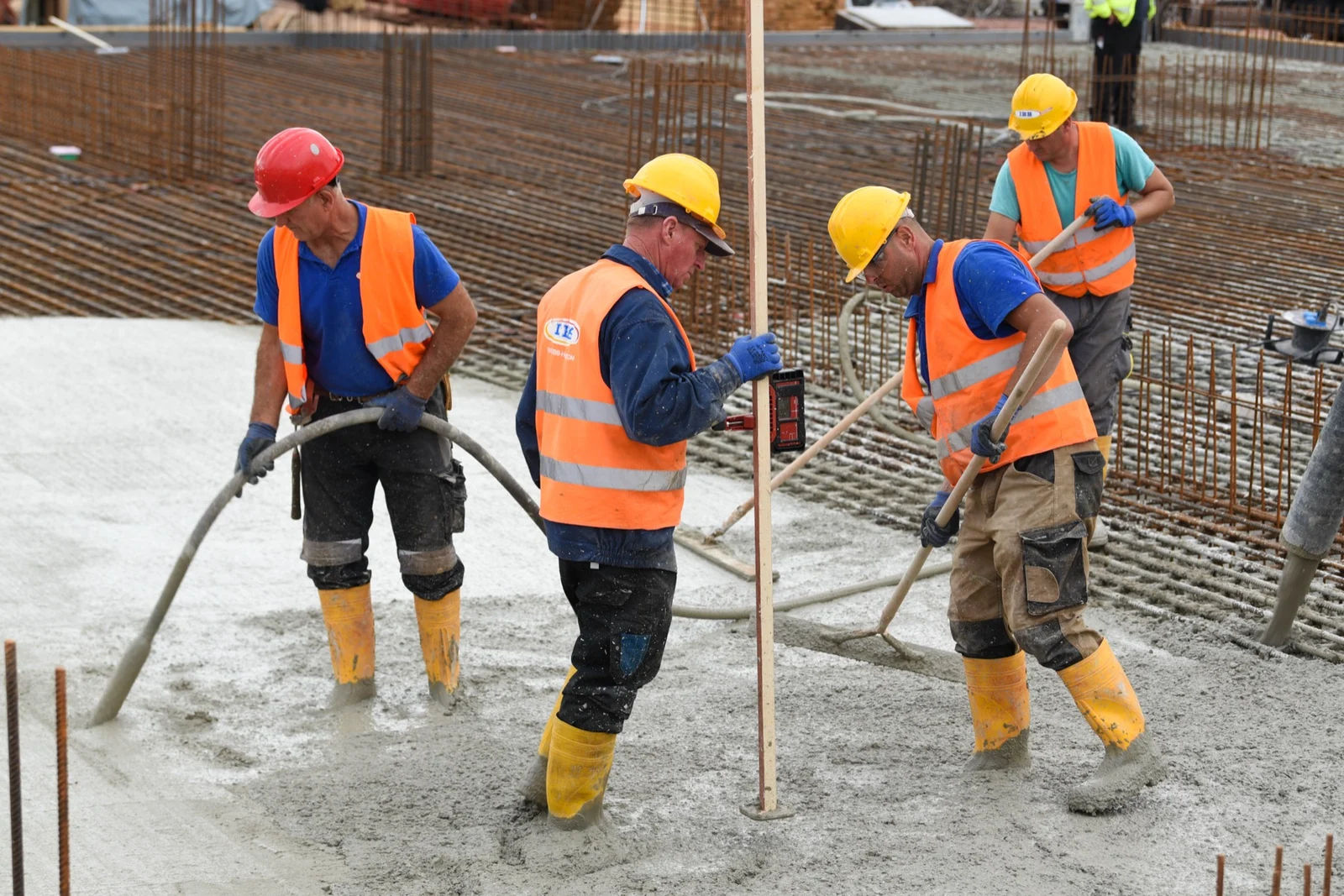 Illustrative stock photo of workers placing and finishing concrete